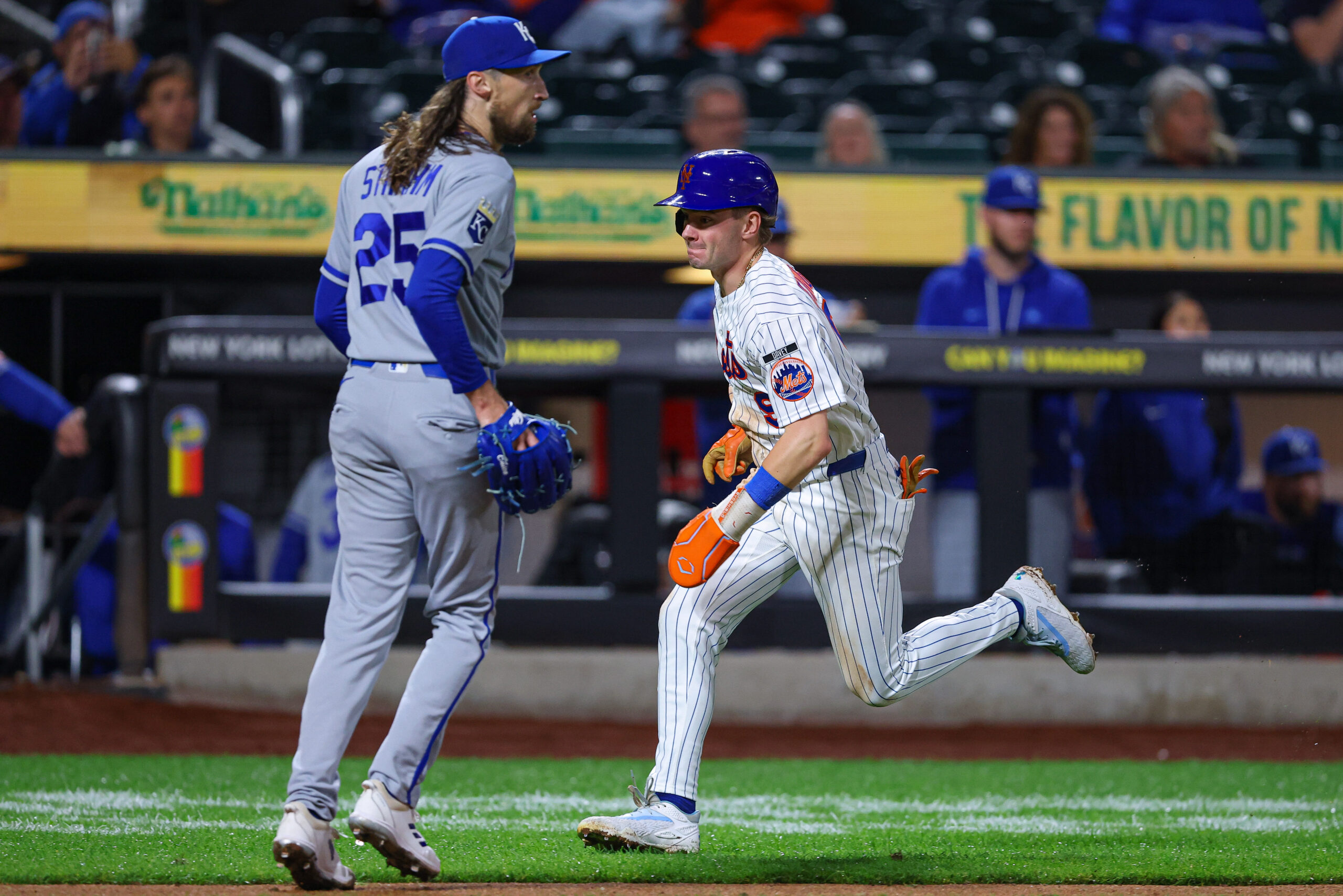 Jul 7, 2026; New York City, New York, USA; New York Mets center fielder A.J. Ewing (9) scores a run as Kansas City Royals pitcher Matt Strahm (25) looks up during the eighth inning at Citi Field. Mandatory Credit: Vincent Carchietta-Imagn Images