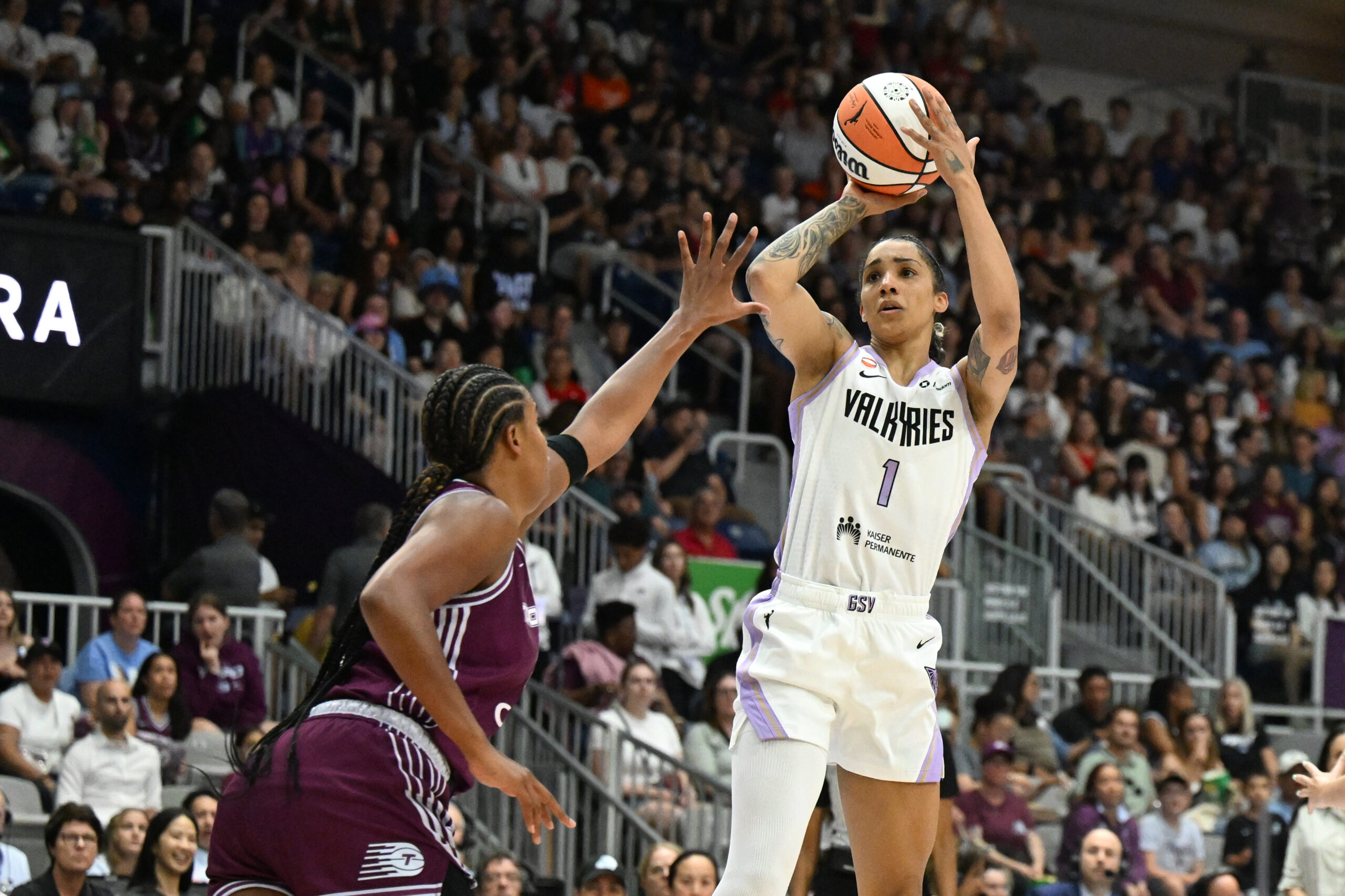 Jul 8, 2026; Toronto, Ontario, CAN;  Golden State Valkyries guard Gabby Williams (1) shoots the ball over Toronto Tempo forward Nyara Sabally (8) in the first half at Coca-Cola Coliseum. Mandatory Credit: Dan Hamilton-Imagn Images