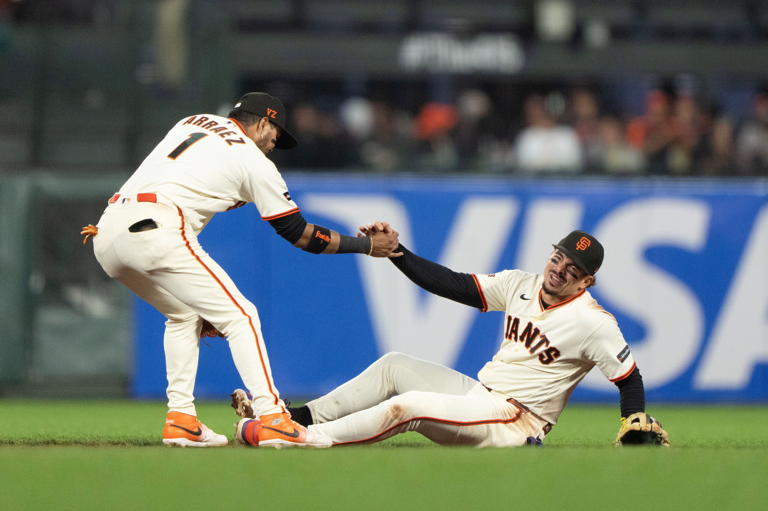 Jul 9, 2026; San Francisco, California, USA; San Francisco Giants second baseman Luis Arraez (1) helps shortstop Willy Adames (2) during the seventh inning against the Colorado Rockies at Oracle Park. Mandatory Credit: Stan Szeto-Imagn Images