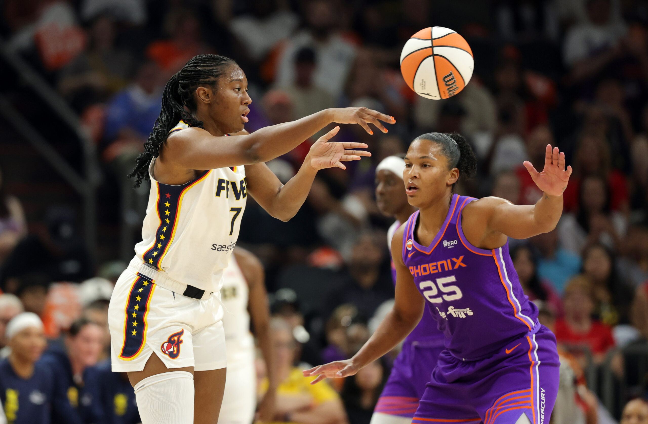 Jul 9, 2026; Phoenix, Arizona, USA; Indiana Fever center Aliyah Boston (7) passes the ball against Phoenix Mercury forward Alyssa Thomas (25) at Mortgage Matchup Center. Mandatory Credit: Mark J. Rebilas-Imagn Images