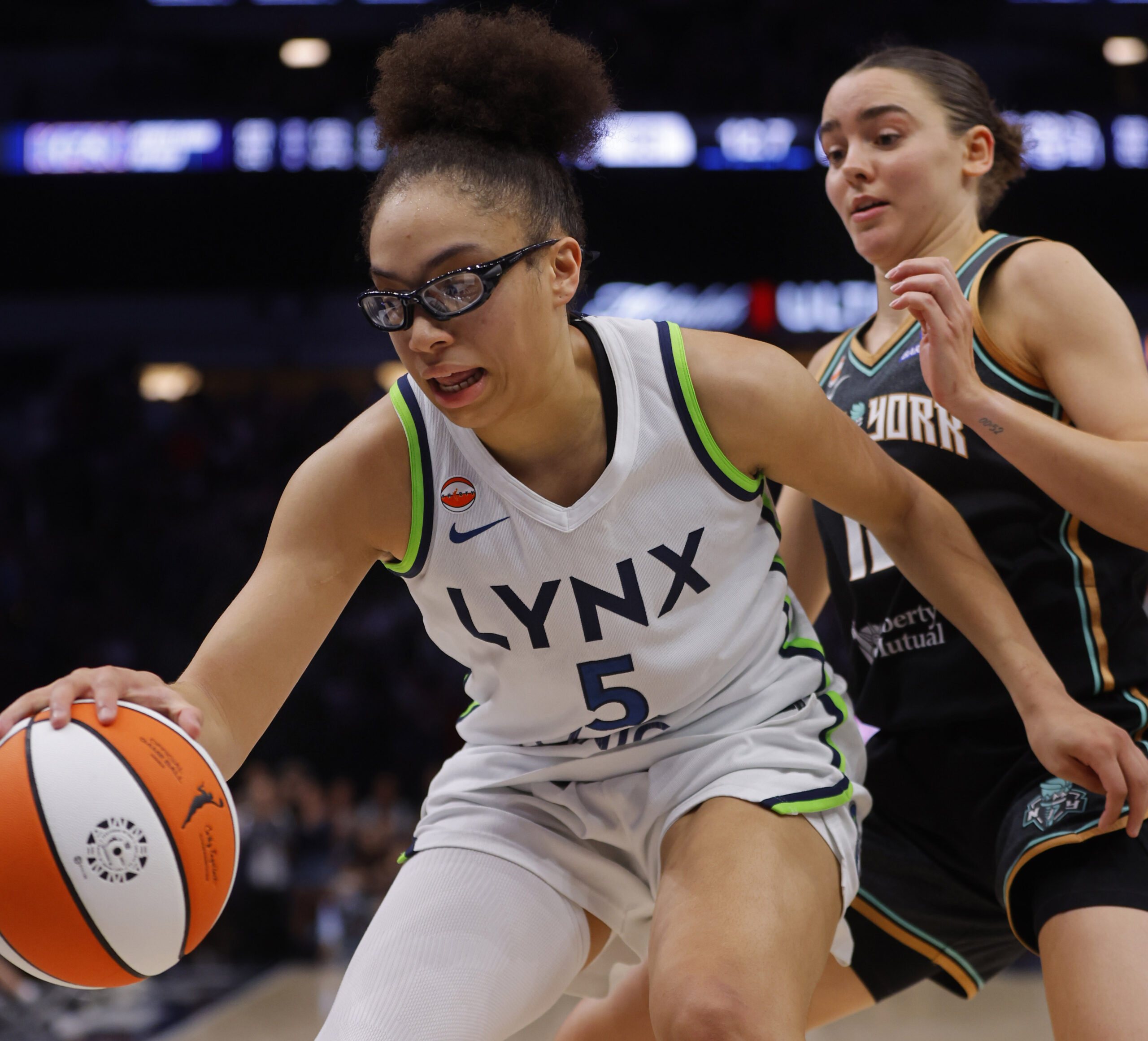 Jul 11, 2026; Minneapolis, Minnesota, USA; Minnesota Lynx guard Olivia Miles (5) grabs a rebound ahead of New York Liberty forward Pauline Astier (18) late in the fourth quarter at Target Center. Mandatory Credit: Bruce Kluckhohn-Imagn Images