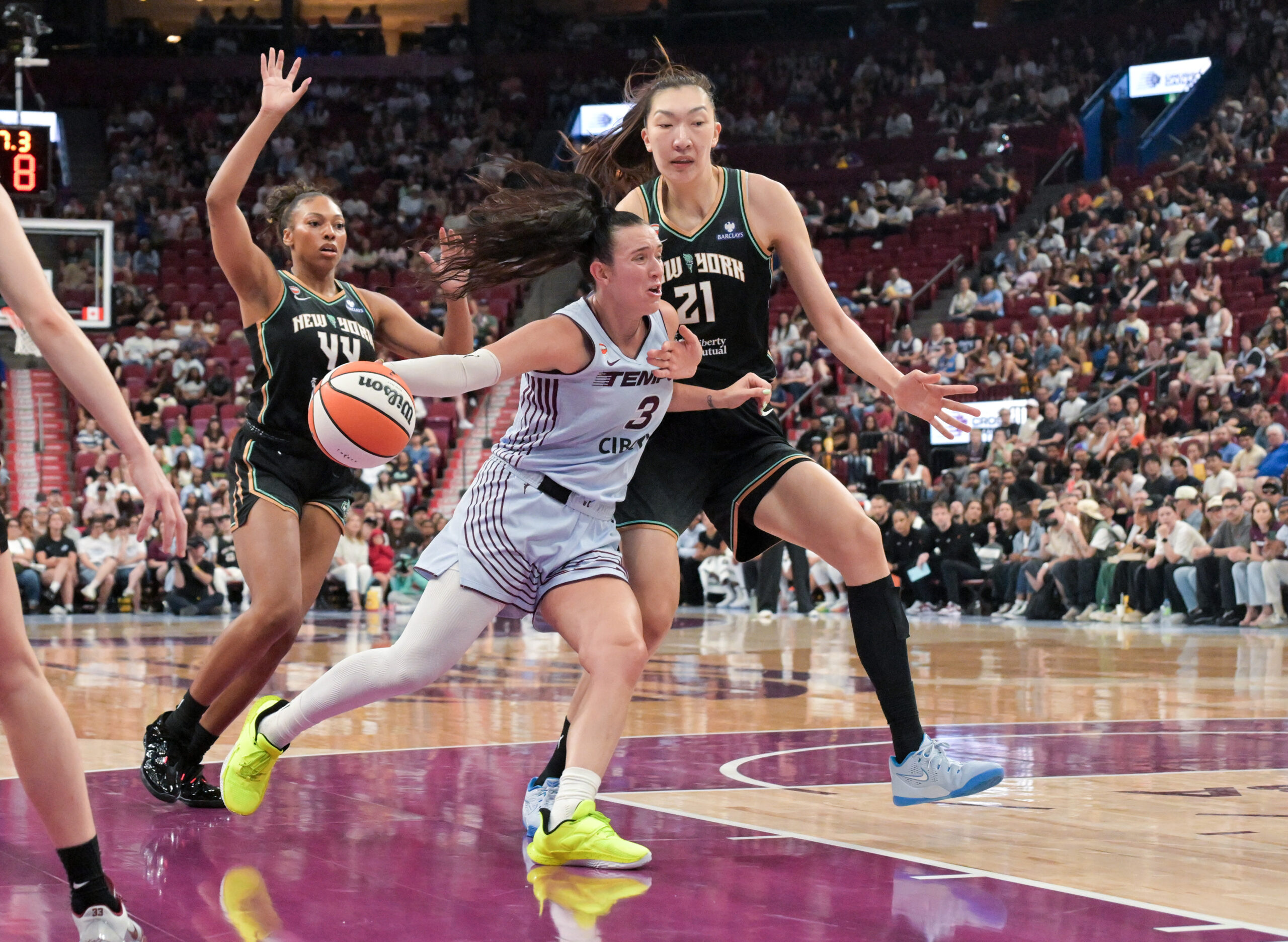 Jul 12, 2026; Montreal, Quebec, CAN; Toronto Tempo guard Marina Mabrey (3) drives to the net and New York Liberty center Han Xu (21) defends with teammate guard-forward Betnijah Laney-Hamilton (44)during the first half at the Bell Centre. Mandatory Credit: Eric Bolte-Imagn Images